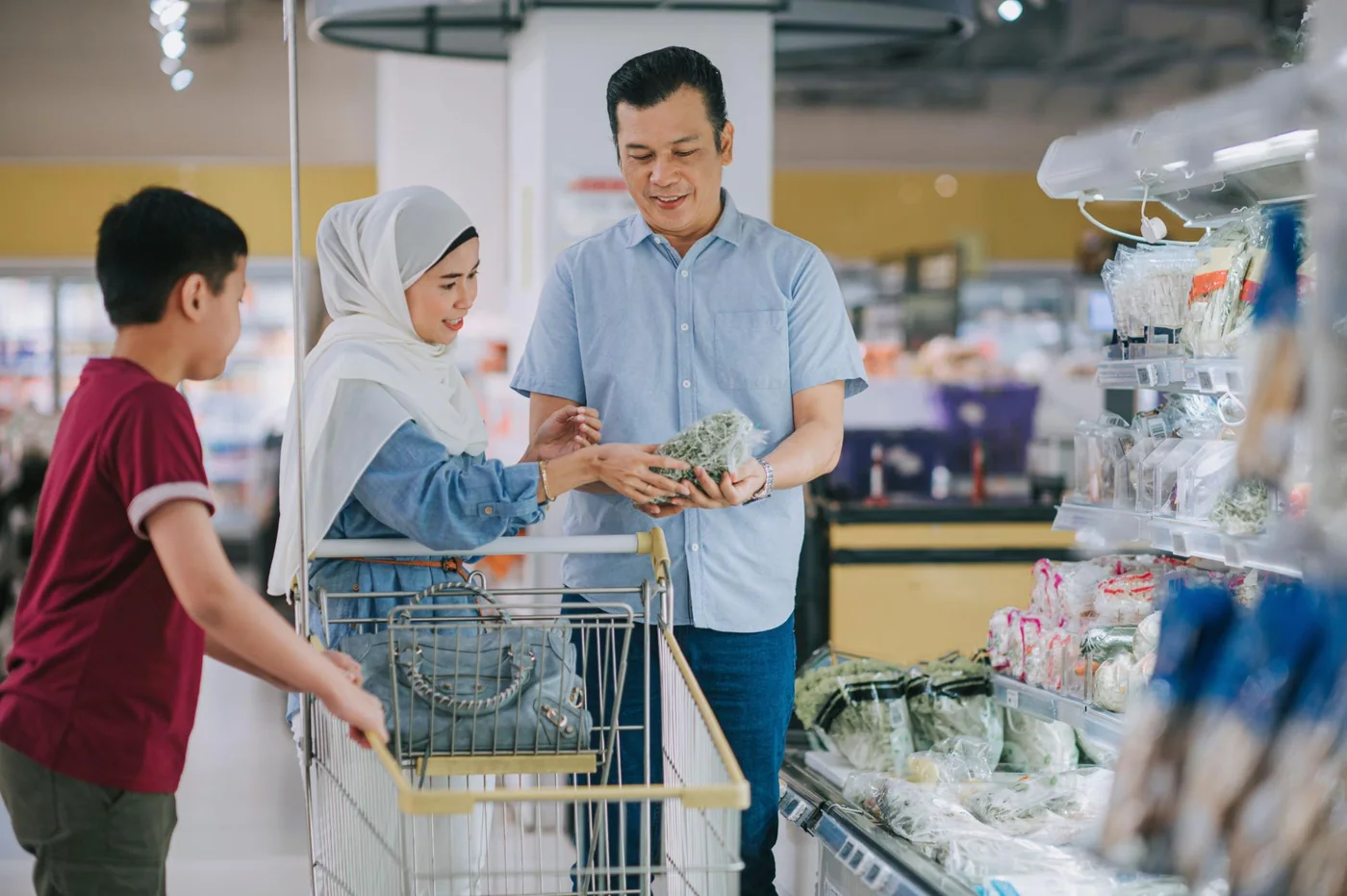 Keluarga Malaysia membeli barangan segar di pasar raya